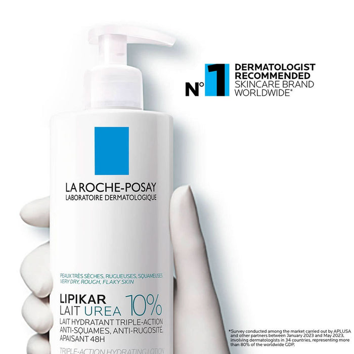 La Roche-Posay Lipikar Lait Urea 10% pump bottle held in gloved hand on white background, labelled "very dry, rough, flaky skin"