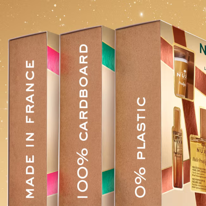 Nuxe Prodigieux 4 Piece Gift Set boxes on gold background reading "Made in France, 100% Cardboard, 0% Plastic"