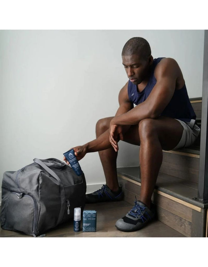 Man using Oars + Alps Muscle Recovery Balm for muscle recovery after workout