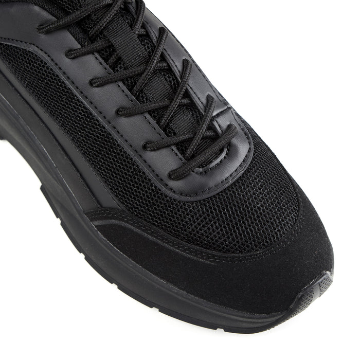 Close up shot of runner trainer in all black showing black mesh detailing