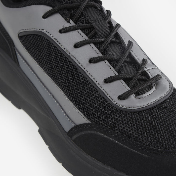 Zoomed in shot of all black runner trainer showing black laces and black mesh panel