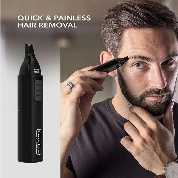 Wahl GroomEase Ear & Nose Trimmer in black beside a man trimming his eyebrow, grey background, text reads "Quick & Painless Hair Removal"