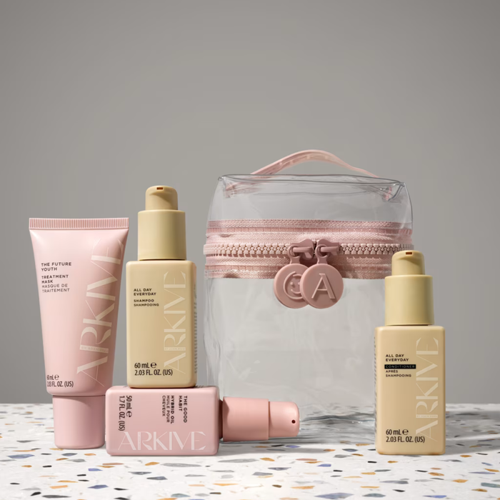 Arkive Head In The Clouds 5 Piece Set with shampoo, conditioner, treatment mask, hair oil, and clear cosmetic bag on terrazzo surface