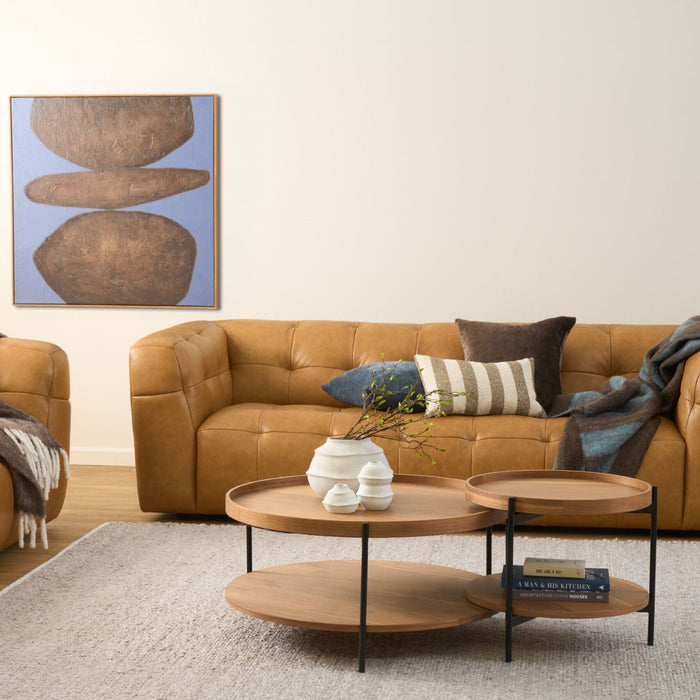 Balance Artwork - Blue/Brown, abstract blue and earthy brown wall art above a tan leather sofa.