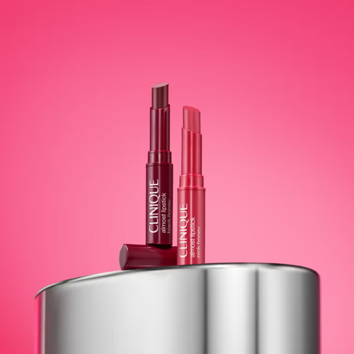 Clinique Cult Classic Lipstick Duo Gift Set showing Almost Lipstick in Black Honey and Pink Honey on a silver tin, pink background.