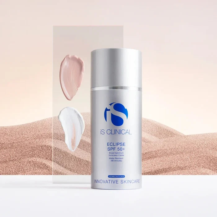 Silver pump bottle of iS Clinical Eclipse SPF 50+ sunscreen with beige and white cream swatches on clear panel