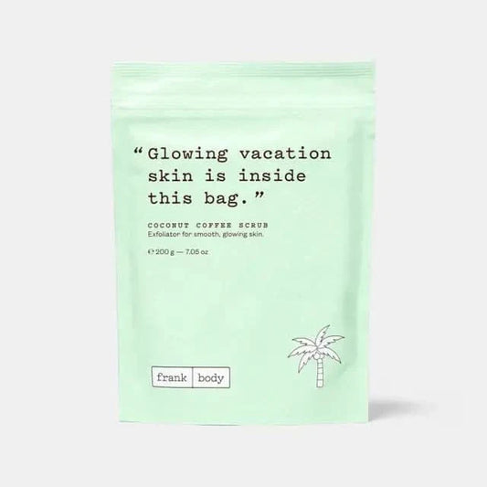 Frank Body Coconut Coffee Scrub 200g in mint green resealable pouch with palm tree illustration on light grey background.