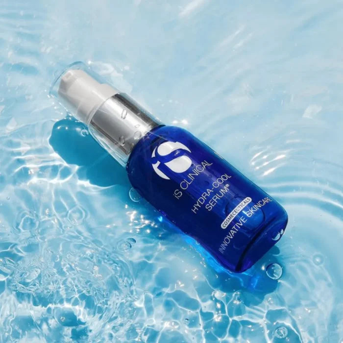 Blue iS Clinical Hydra-Cool Serum bottle with silver pump floating in clear water