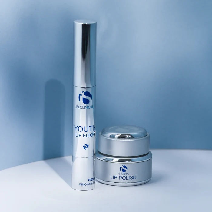 iS Clinical Youth Lip Elixir in tall silver tube and Lip Polish in small silver jar on white surface with blue background