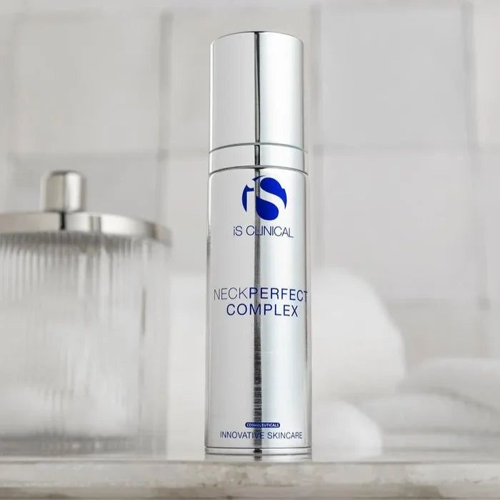 Silver cylindrical bottle of iS Clinical NeckPerfect Complex with blue logo and text on reflective surface