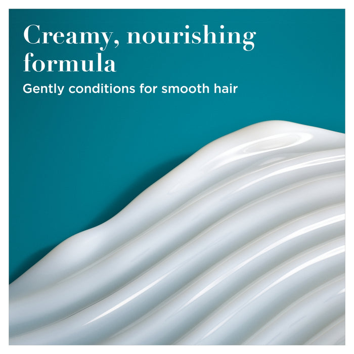 OGX Nourishing+ Coconut Milk Conditioner creamy white formula texture on teal background, text reads "Creamy, nourishing formula"
