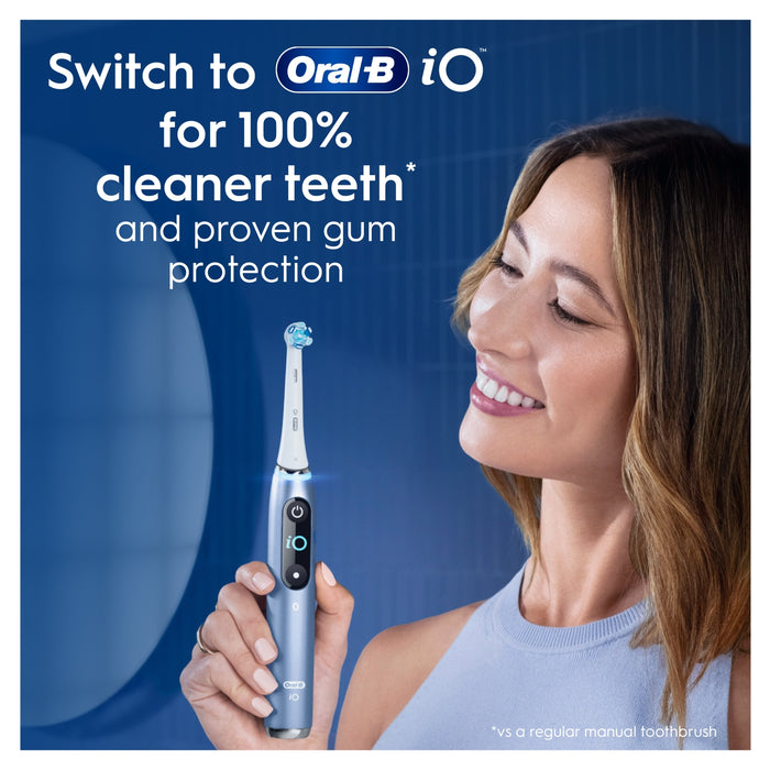 Woman holding Oral-B iO electric toothbrush on blue background, text reads "Switch to Oral-B iO for 100% cleaner teeth and proven gum protection"