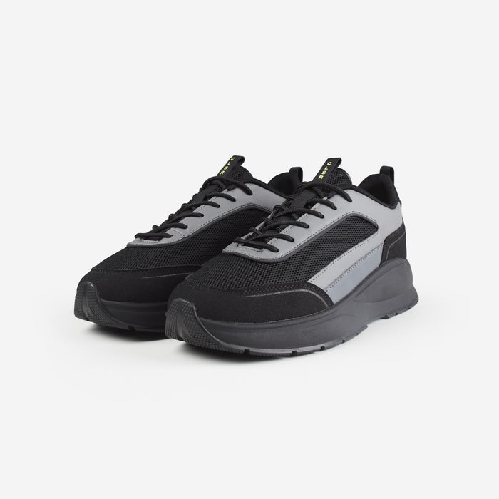 Pair of black runner trainers with mesh detailing and grey panels shot on white background