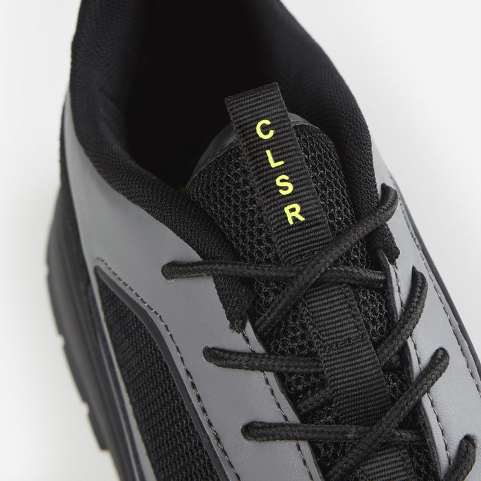 Zoomed in shot of black runner trainer with CLSR detailing on tongue strap