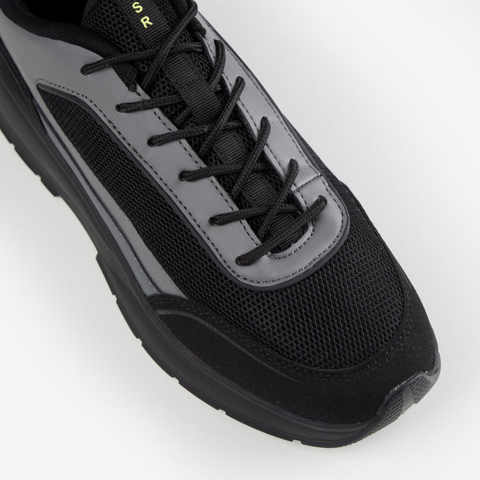 Close up shot of black runner trainer showing mesh detailing