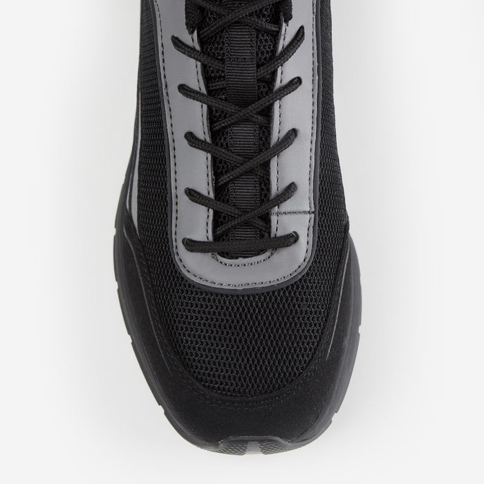Close up shot of black runner trainer focusing on mesh detailing