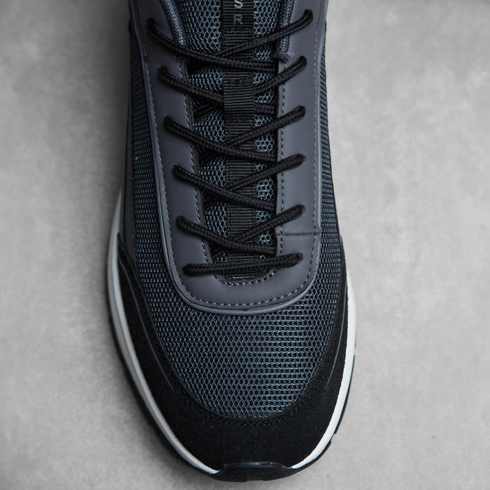 Birds eye view of black runner trainer showing dark mesh panelling and black laces
