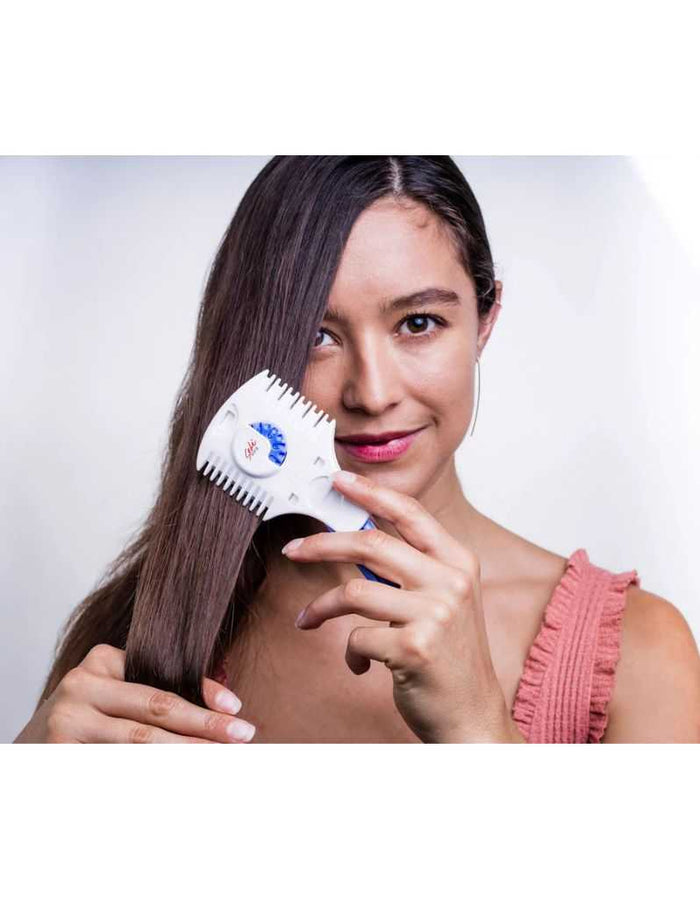 Woman using haircutting styling razor on long brown hair