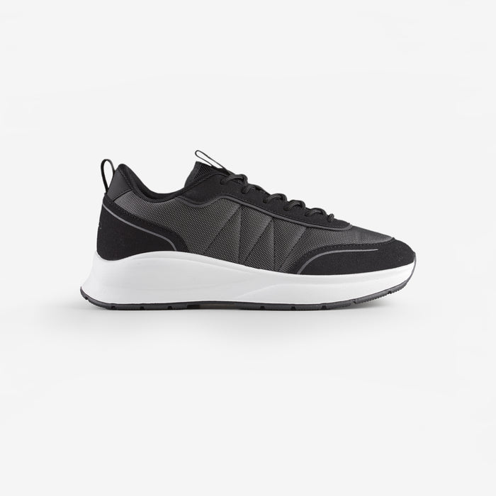 Side view of smart runner trainers in black shot on white background
