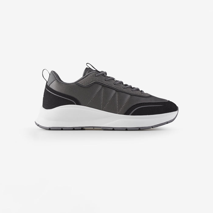 Side view of smart runner shoe in charcoal with white sole shot on white background
