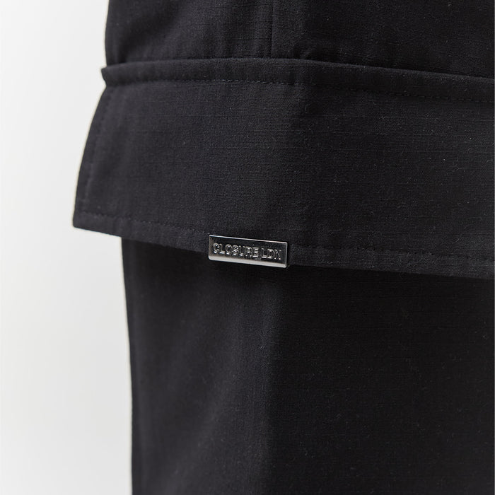 Close up of Closure London branding on utility pants trousers pocket in black