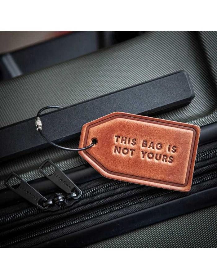 Leather luggage tag on suitcase handle