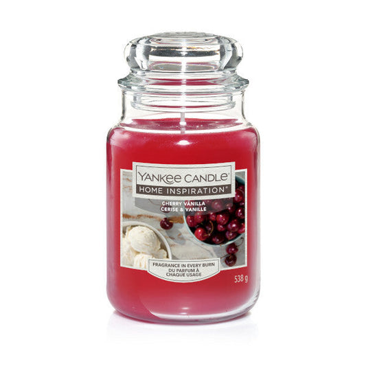 Yankee Candle Cherry Vanilla 538g large jar candle with red wax and glass lid on white background.